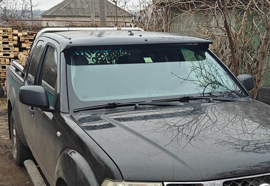 The visor on the windshield (on the frame) for Nissan Navara 2006-2015 - Reelken Auto