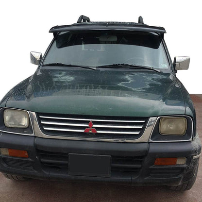 The visor on the windshield (gloss black, 5mm) for Mitsubishi L200 1996-2006 - Reelken Auto